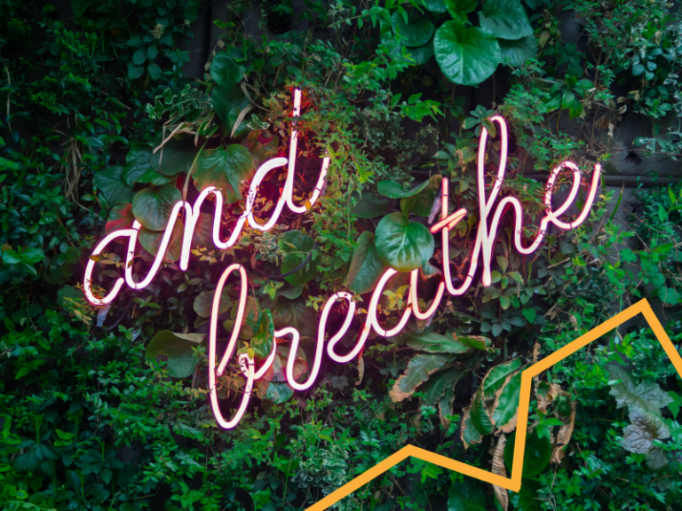 An 'and breathe' sign on a foliage background
